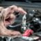 Tune hood unrecognizable mechanic repairman shining screwdriver